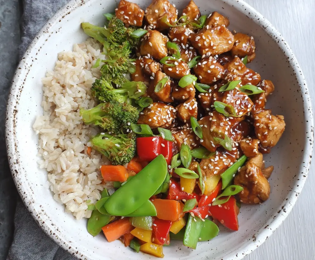 Delicious healthy sesame chicken dish served on a plate with garnish